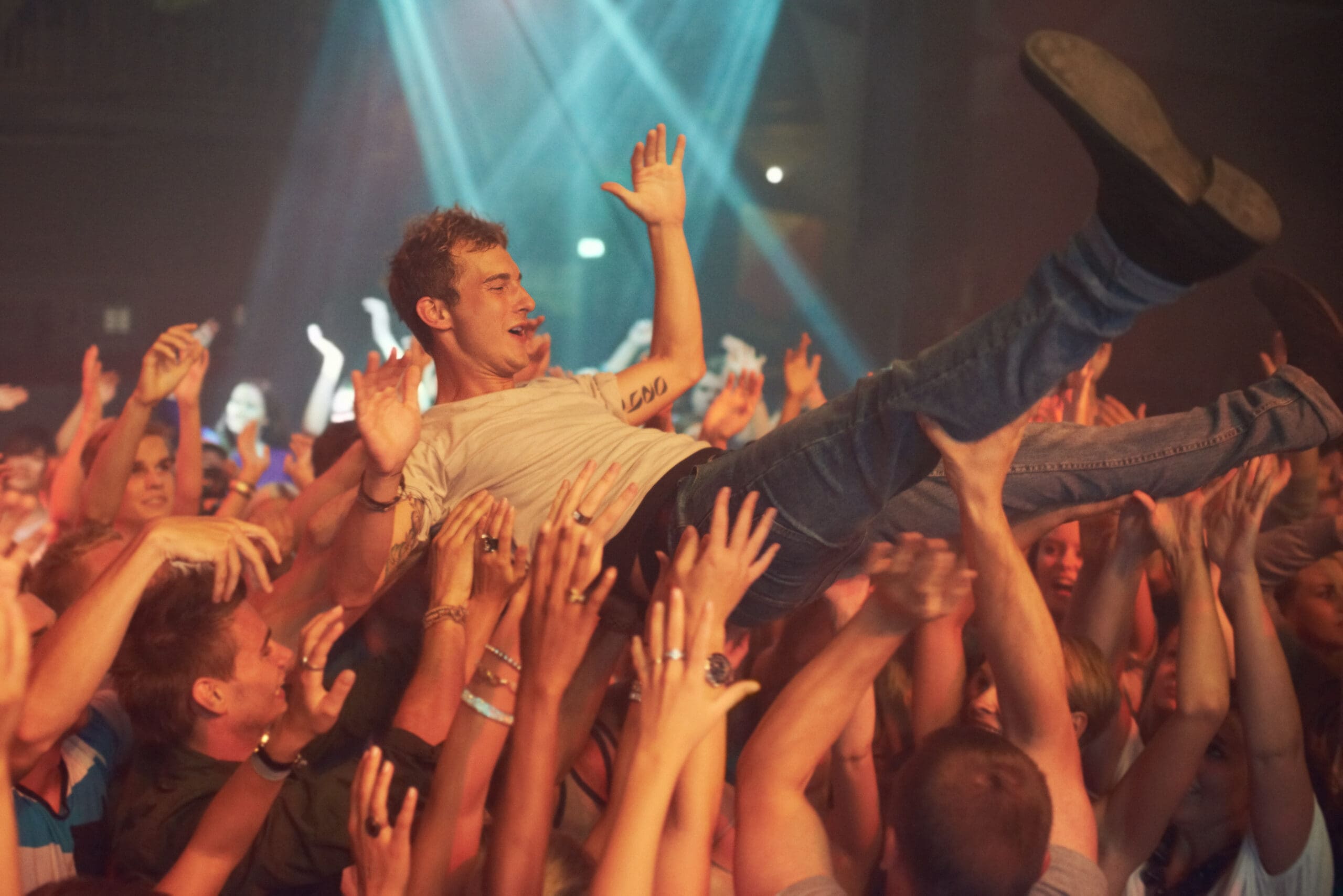 Man crowd surfing above an audience